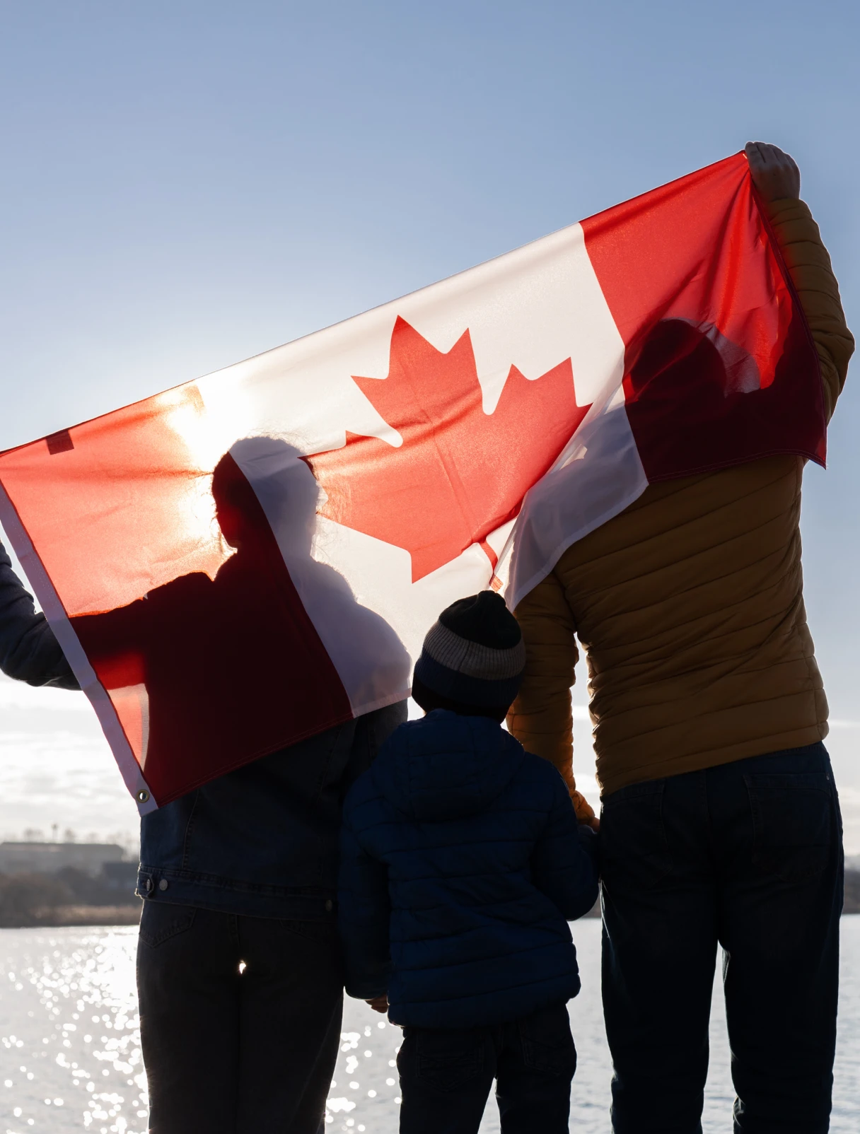 family holding up canadian flag